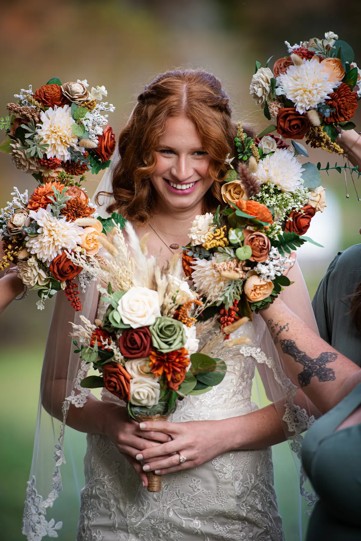 Bride holding a colorful bouquet surrounded by flowers